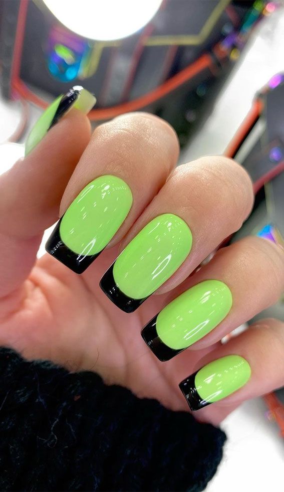 Chic and Playful: Vibrant Green Nails with Sleek Black Tips