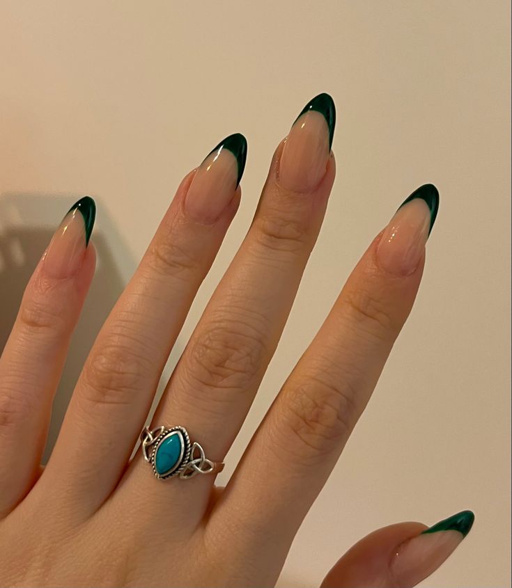 Chic Almond-Shaped Nail Design with Dark Green Ombre and Stylish Accents.