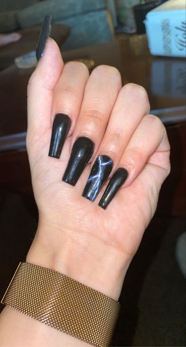 Elegant Black Nail Design with Glossy Finish and Striking Marble Accent