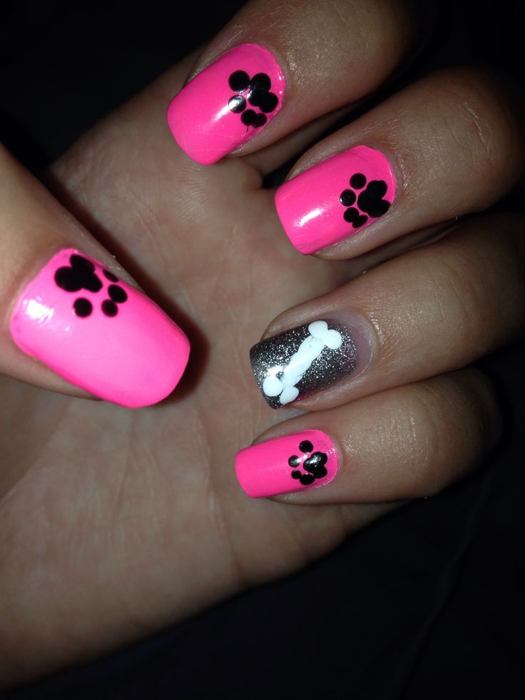 Vibrant Pink Nail Design with Playful Paw Prints and Silver Bone Accent for Animal Lovers