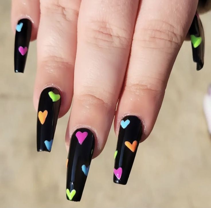 Vibrant Colorful Heart Nail Art on a Sleek Black Background for a Playful Trendy Look