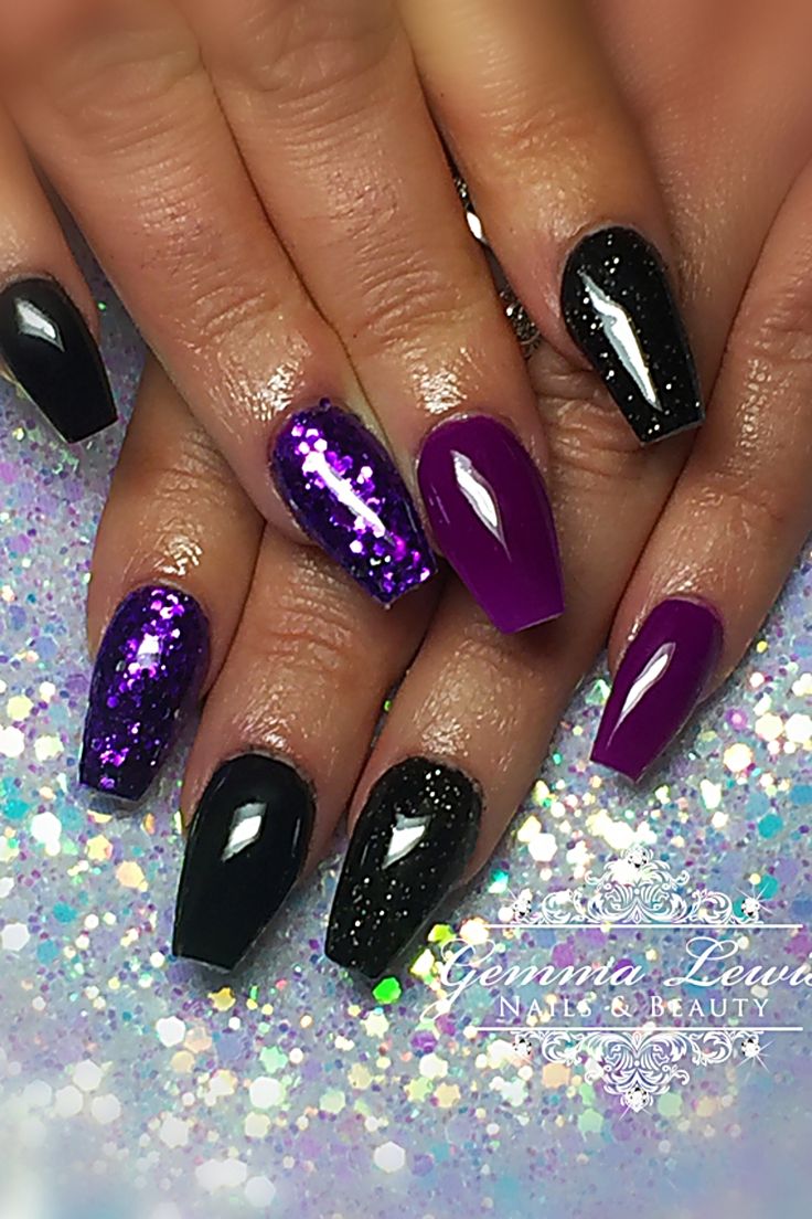 Chic Elongated Black and Deep Purple Nail Design with Glamorous Glitter Accents.