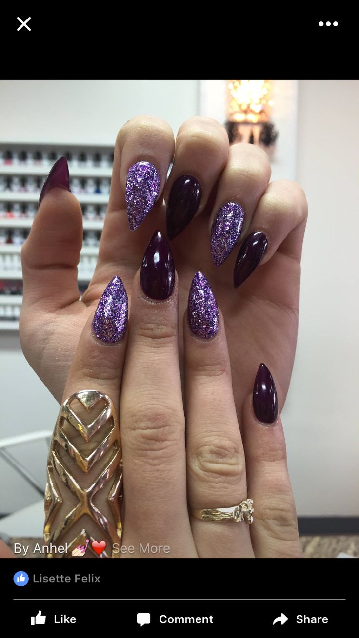 Glamorous Stiletto Nail Design: Deep Purple and Glitter Accents with Gold Jewelry.