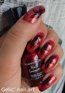 Elegant Bold Red Nail Design with Delicate Black Leaf Patterns.