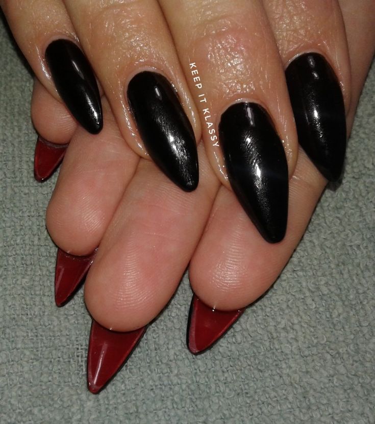 Chic Stiletto Nails: Glossy Black with Fiery Red Tips for a Bold Statement.