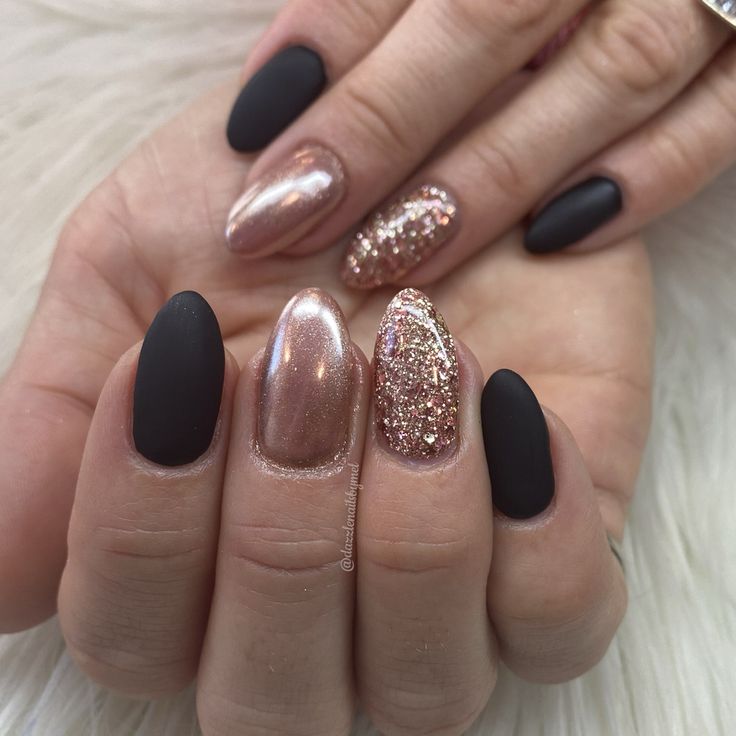 Chic Matte Black and Shimmering Rose Gold Nail Design with Glitter Accents.