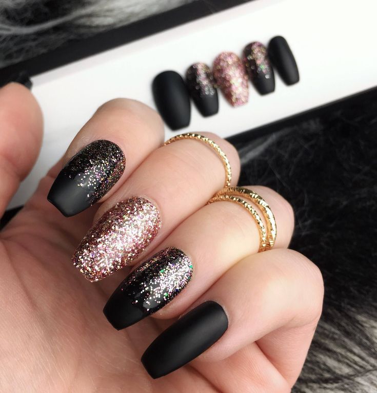 Chic Matte Black and Glitter Nail Design with Pink and Gold Accents for Glamorous Occasions.