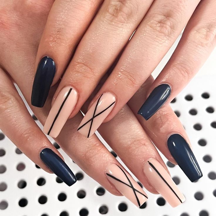 Elegant Navy Blue and Soft Nude Nail Design with Modern Geometric Patterns.