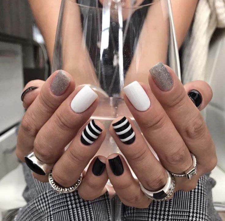 Bold and Glamorous Striped Nail Design with Classic Colors and Glitter Accents.