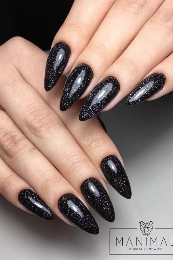 Glamorous Black Stiletto Nails with Shimmering Glitter for a Striking Statement.