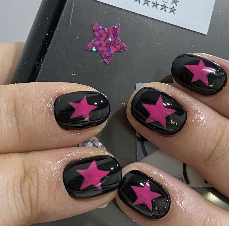 Bold Star-Themed Nail Design: Striking Black Base with Vibrant Pink Stars for a Playful Touch.