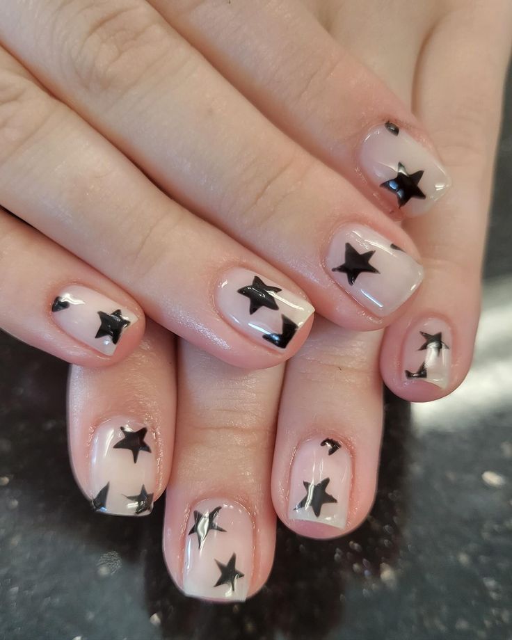 Chic Starry Nail Design: Playful Black Stars on a Nude Base