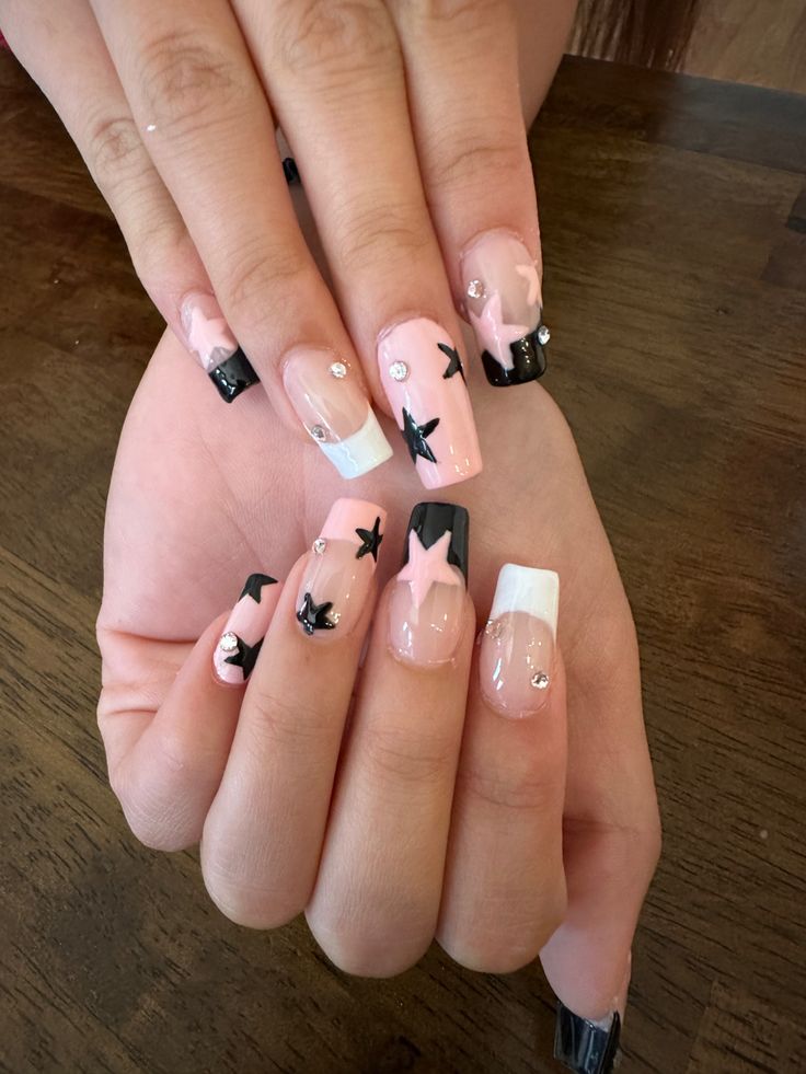 Whimsical Chic: Colorful Nail Design with Pink, Black Stars, and Rhinestones