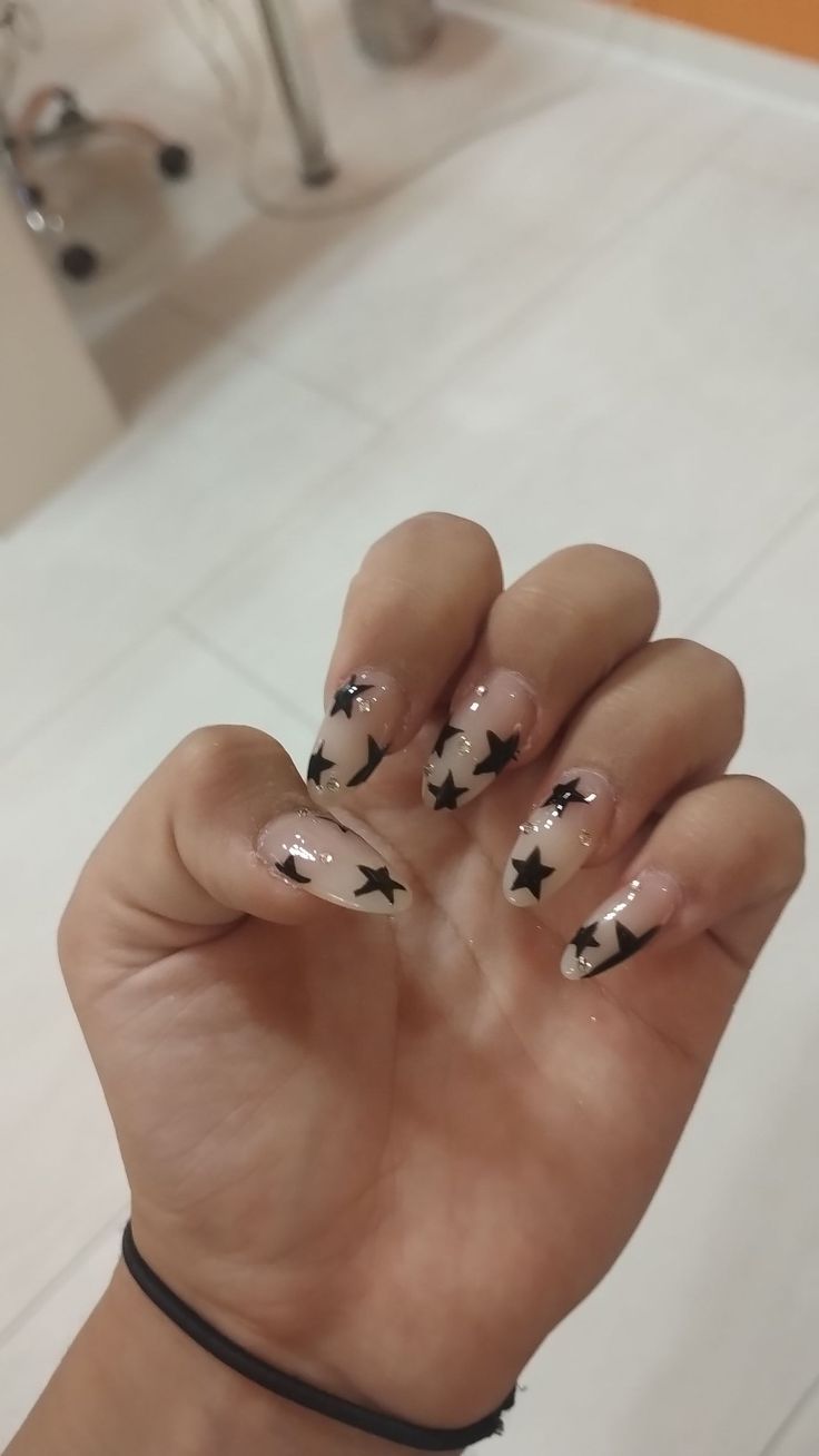 Elegant Star-Themed Nail Design: Striking Contrast of Nude and Glossy Finishes