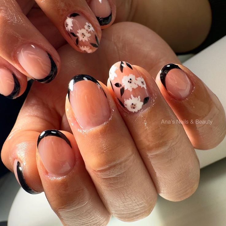 Sophisticated Nude and Black Nail Design with Floral Accents