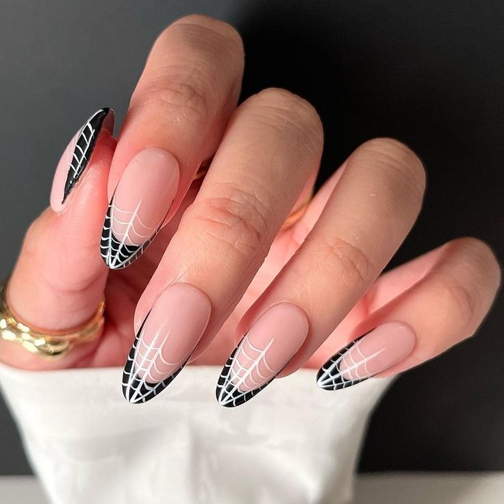 Chic Nude and Black Nail Design with Intricate White Spiderweb Patterns