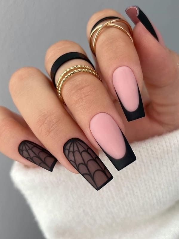 Chic Matte Black and Soft Pink Nail Design with Intricate Spiderwebs and Gold Accents.