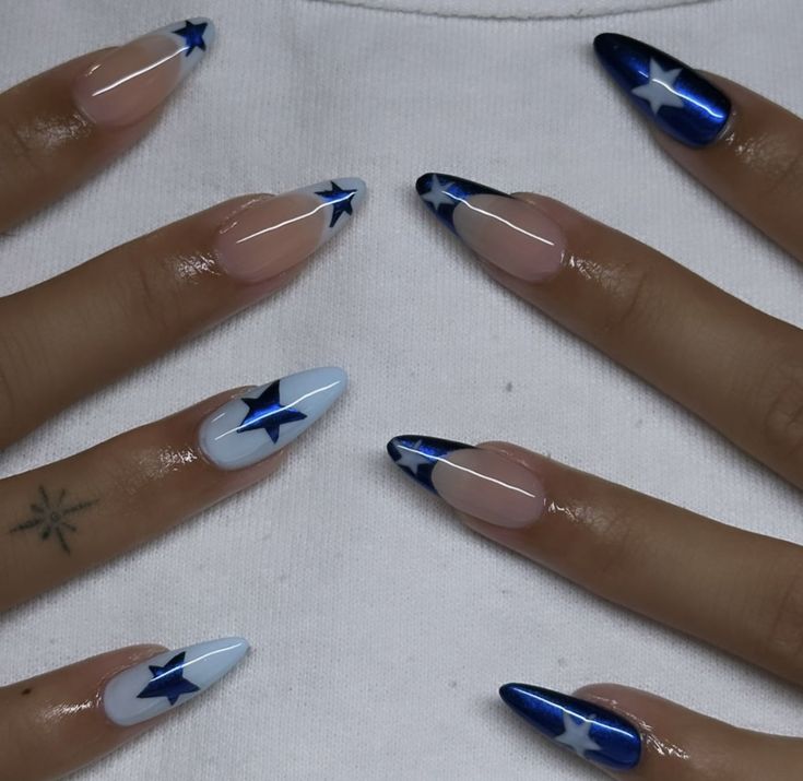 Whimsical Star-Themed Nail Design in Navy and Light Blue with Elegant Almond Tips.