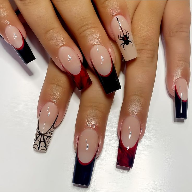 Chic Autumn Nail Design: Nude and Deep Red with Black Accents and Spooky Motifs.