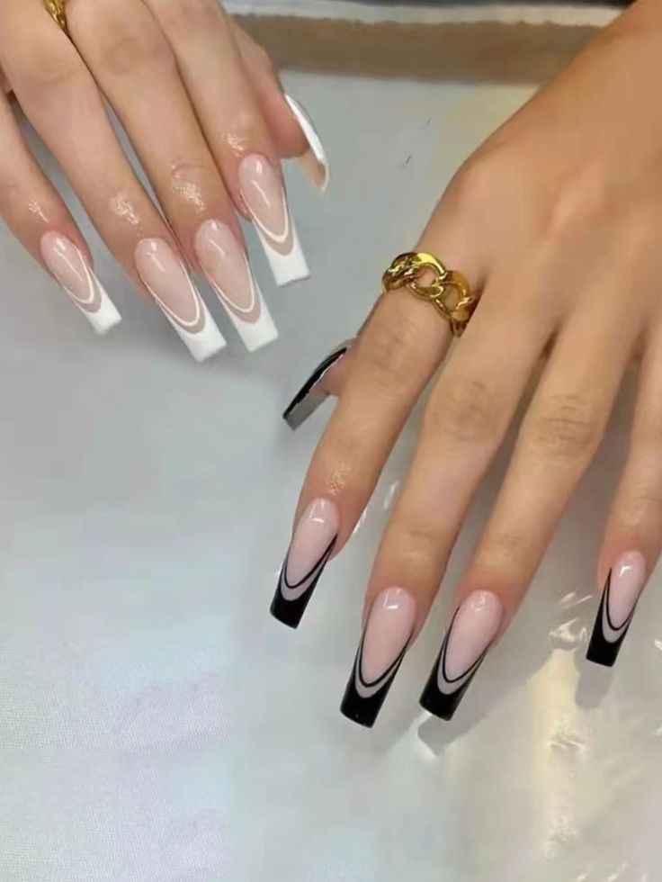 Sophisticated Nail Art: Elegant Nude with Edgy Black and White Tips