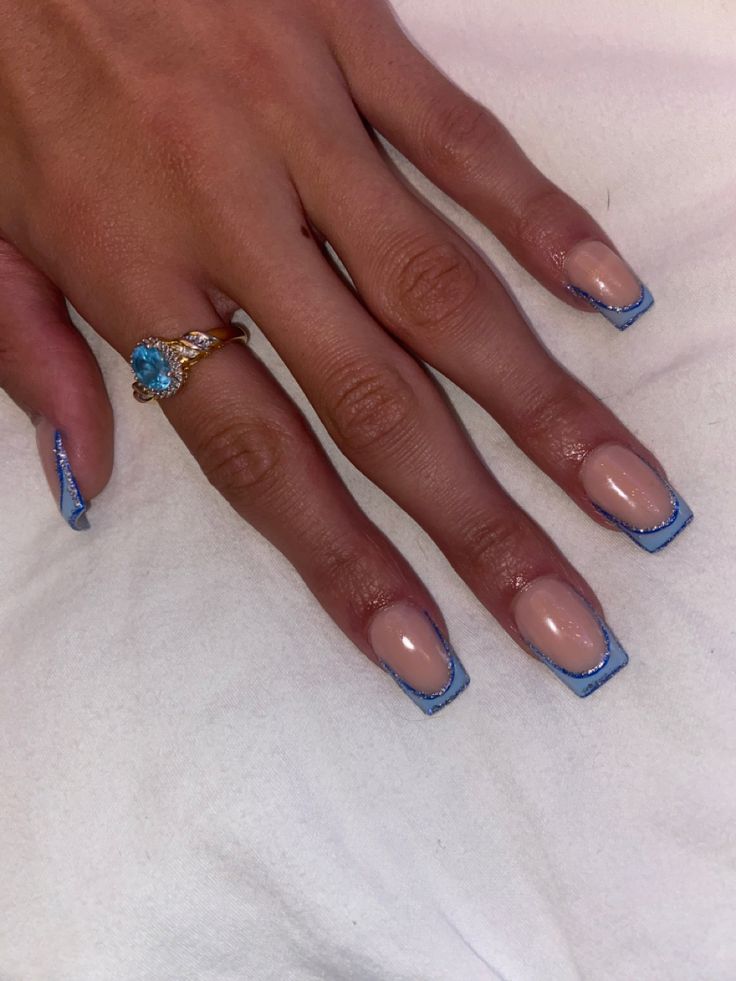 Chic Nude Base with Striking Blue Tips: A Sophisticated Nail Design for Any Occasion.