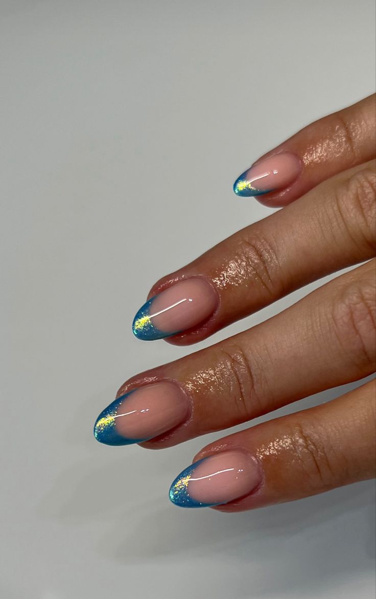 Elegant Pink Base Nail Design with Striking Blue Tips and Glitter Accents