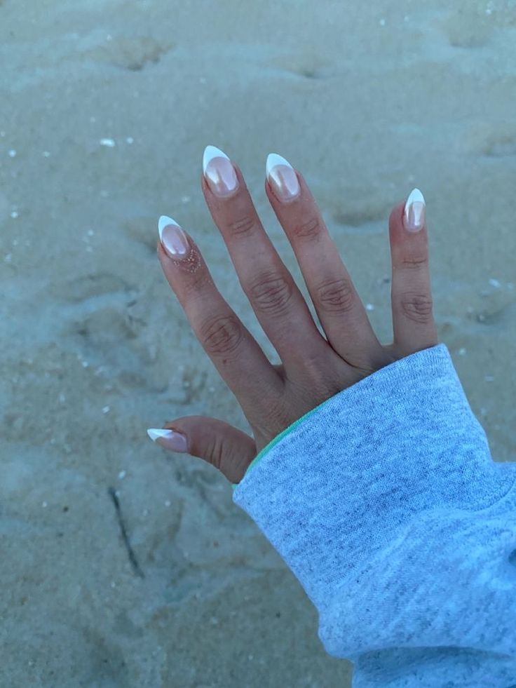 Chic Almond-Shaped Nails: Modern French Manicure with Nude Base and White Tips.