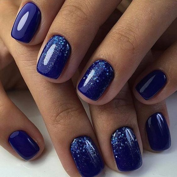 Chic Glittering Navy Manicure with Sparkling Gradient Effect.