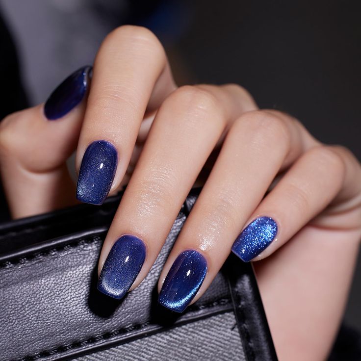 Chic Deep Blue Ombre Nail Design with Glitter Accents for Elegant Evenings.