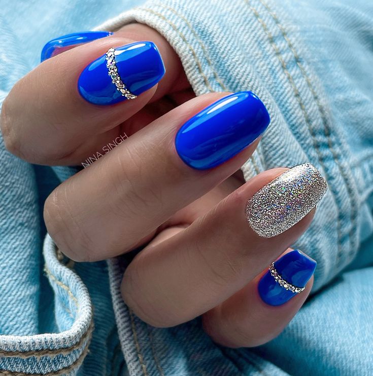 Elegant Vibrant Blue Nails with Glittery Accent for a Glamorous Look.