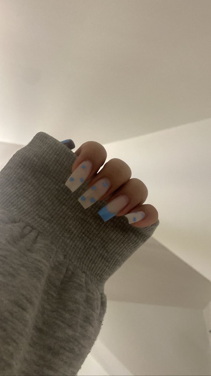 Chic Pastel Nail Design: Light Blue and Soft Pink Squares with Whimsical Dots.