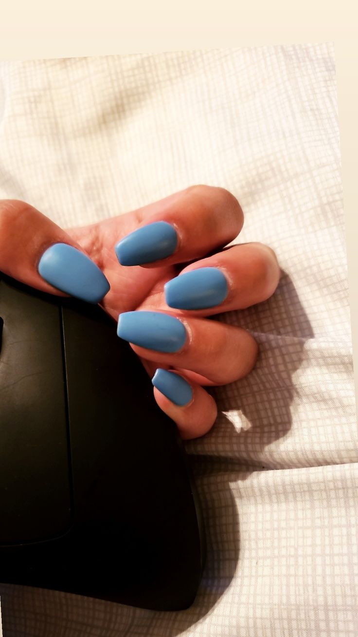 Chic Elongated Blue Matte Nails: A Sophisticated Yet Playful Design.