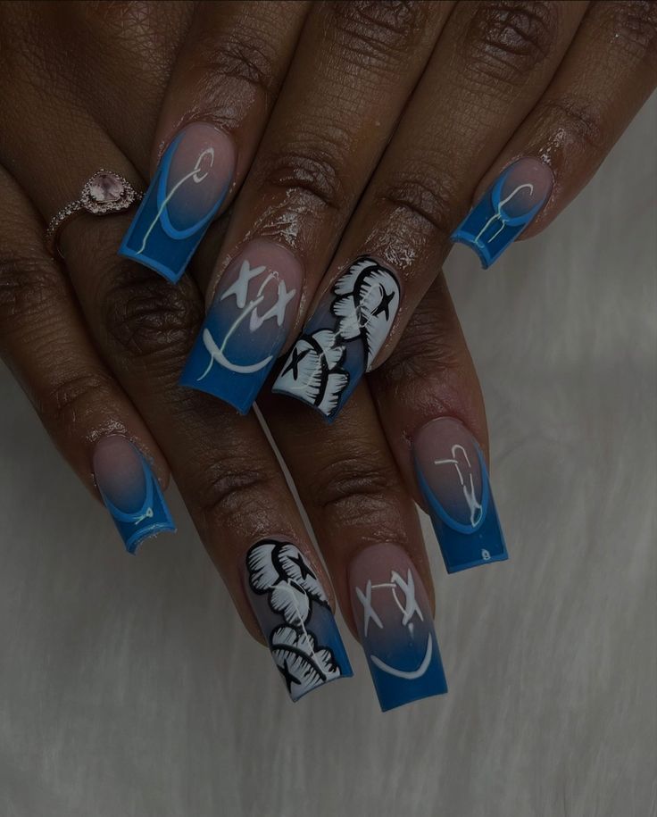 Artistic Vibrant Blue Nail Design with Graceful Patterns and Gradient Finish.