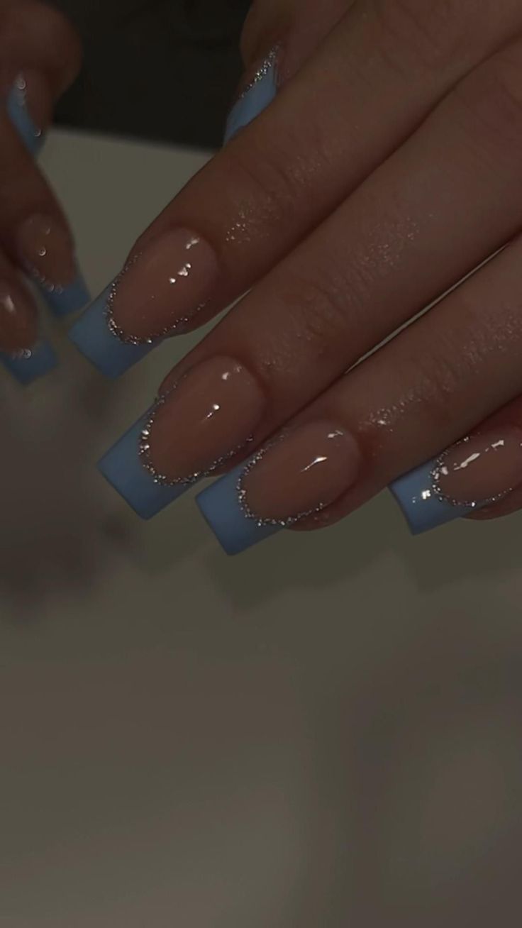 Chic Soft Blue French Tip Nail Design with Glossy Finish and Shimmering Accents.