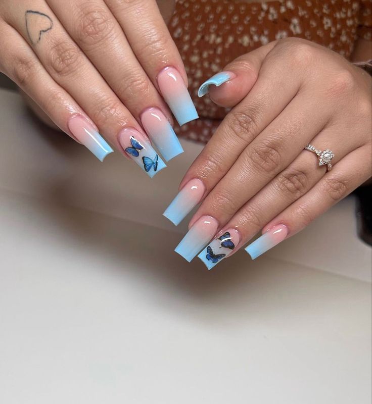 Elegant Gradient Blue Nail Design with Whimsical Butterfly Decals on Modern Square Tips.