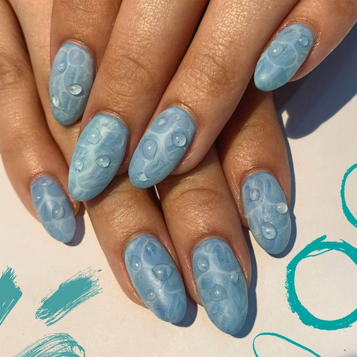 Trendy Blue Marbled Nail Design with Serene Underwater Effect and Glossy Bead Accents