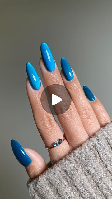 Chic Vibrant Blue Almond Nail Design with Glossy Finish and Dainty Ring Accents