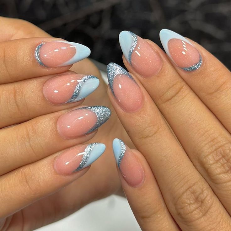 Chic Almond-Shaped Nails in Soft Pink and Pastel Blue with Shimmering Silver Wave Accents.