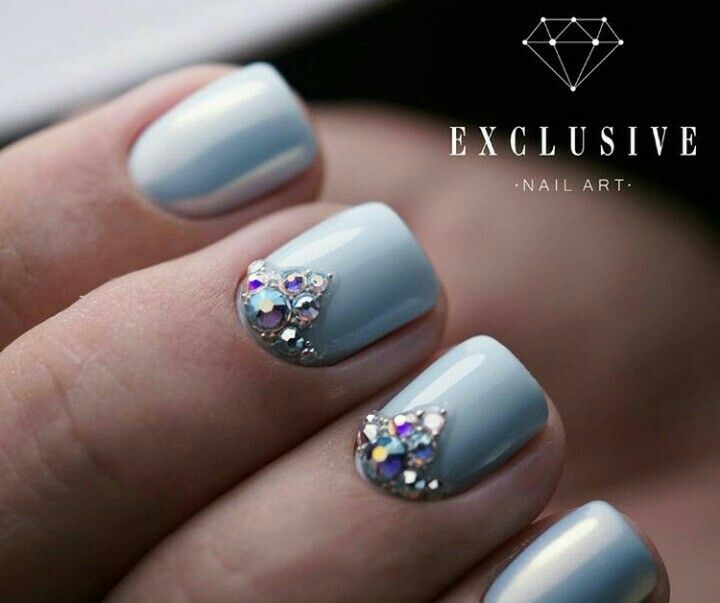 Sophisticated Pastel Blue Nail Design with Sparkling Rhinestone Embellishments.