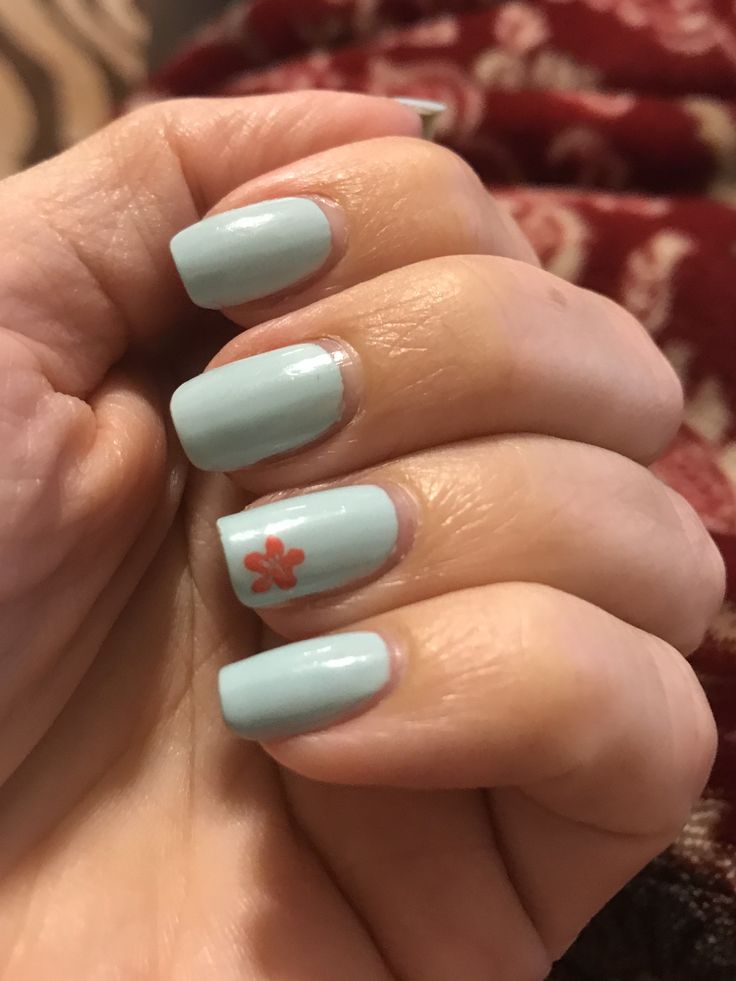 Elegant Pastel Blue Nail Design with Delicate Floral Accent for a Refreshing Spring Look.