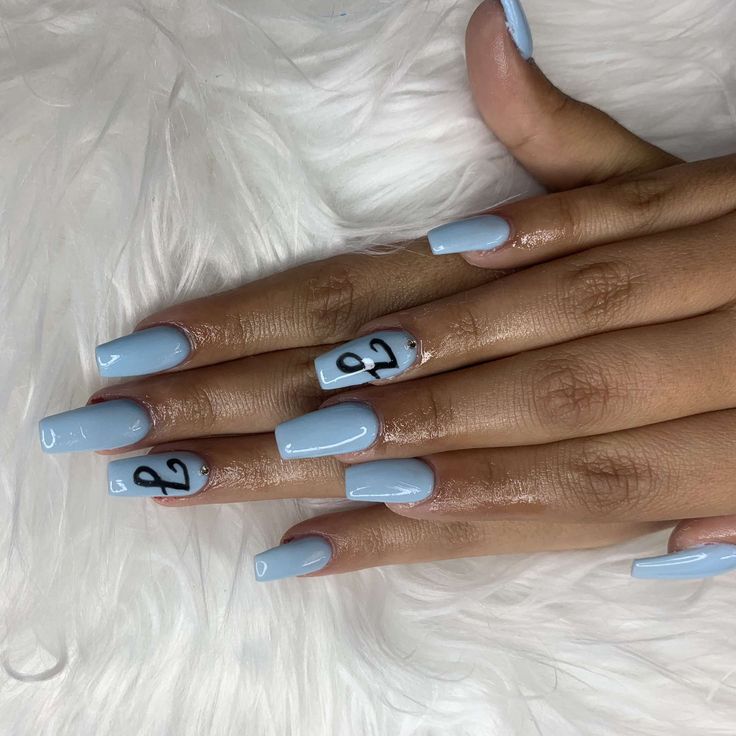 Chic Light Blue Nail Design with Glossy Finish and Contrasting Black Elements for a Modern Twist.