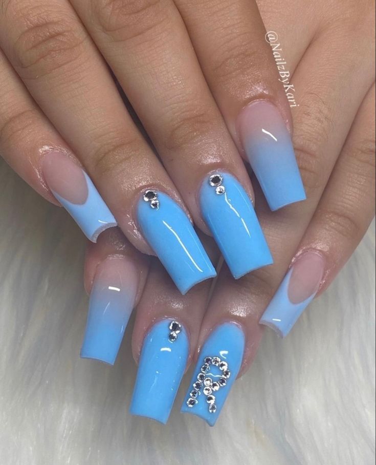 Elegant Ombre Manicure: Soft Blue Gradient with Nude Tips and Sparkling Rhinestones.