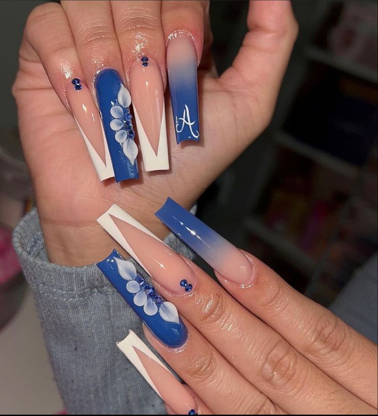 Chic Blue and White Gradient Nail Design with Floral Accents.