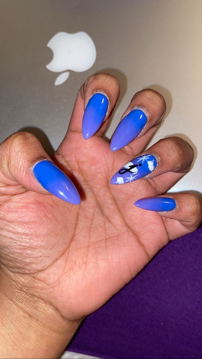 Elegant Vibrant Blue Nail Design with Gradient Shades and Floral Accent.