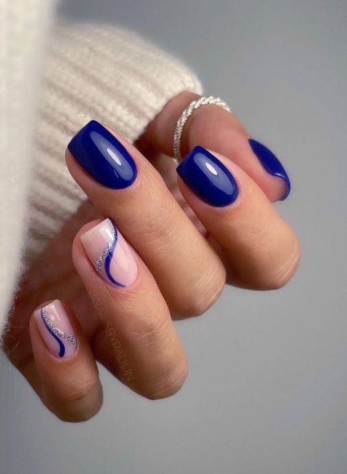 Elegant Blue and Nude Nail Design with Shimmering Silver Accents.