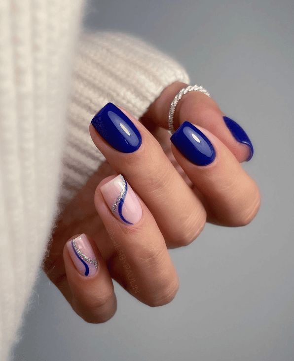 Sophisticated Nail Art: Bold Deep Blue with Whimsical Pink Accents and Silver Waves