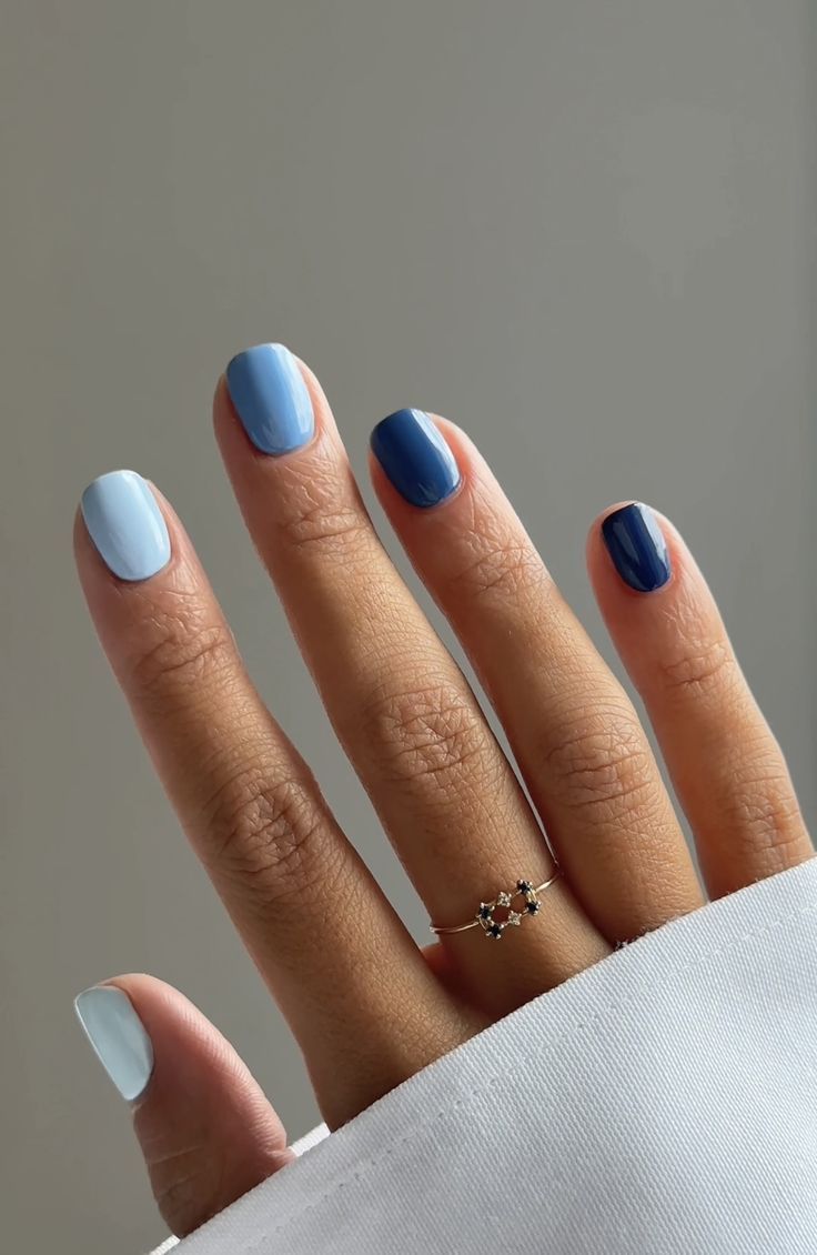 Elegant Blue Gradient Nail Design Enhanced by Minimalistic Jewelry.