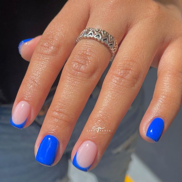 Chic Vibrant Blue and Soft Nude Nail Design with Glossy Finish: A Modern Take on French Tips.