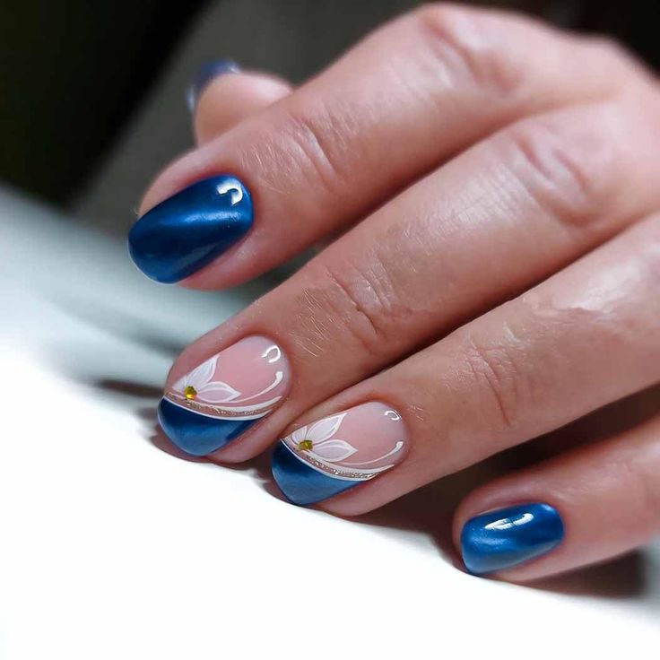 Sophisticated Nail Design with Striking Blue Palette, Floral Accents, and Captivating Contrast.