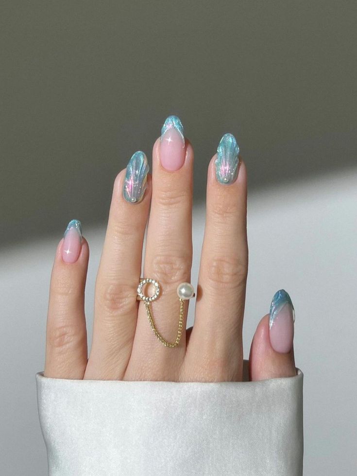 Dreamy Pastel Pink and Shimmering Blue Nail Design with Glossy Finish and Elegant Ring Accents.